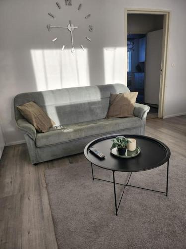 a living room with a couch and a coffee table at Gáiju Apartment 