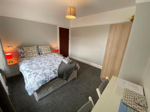 a bedroom with a bed and a table and chairs at Crumlin Road Town House in Belfast
