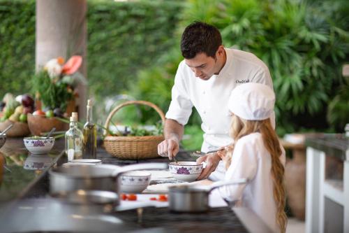 a man and a little girl preparing food in a kitchen at One&Only Palmilla in San José del Cabo