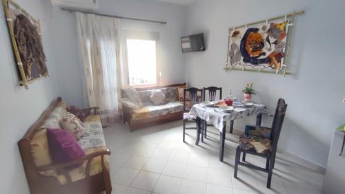 a living room with a table and a couch at 10 apartmants Olimpia MIR in Durrës