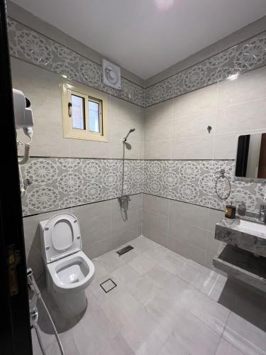 a bathroom with a toilet and a sink at السلطان للشقق المفروشة in AlUla