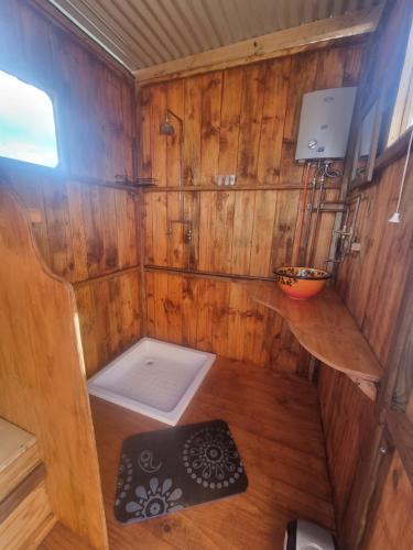 an inside view of a wooden cabin with a small toilet at Pom Gratz - EcoDomes in Hartebeest Rivier