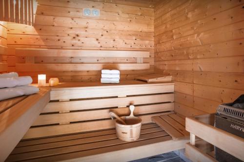 a wooden sauna with a bucket in it at Chalet Flocon Magique - OVO Network in Saint-Jean-de-Sixt