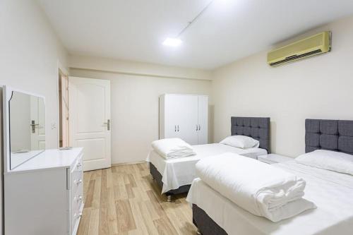 a hospital room with two beds and a sink at Lamartin in Istanbul