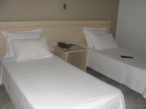 Katil atau katil-katil dalam bilik di Manhuaçu Center Hotel