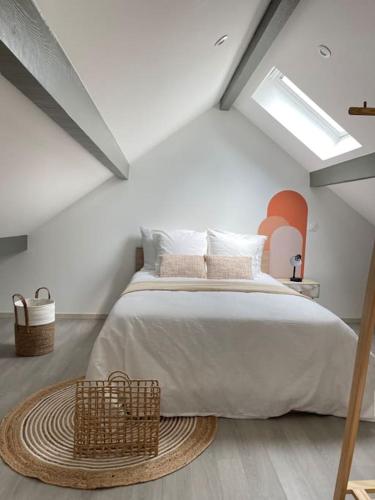 a bedroom with a large bed in a attic at La Bohème in Challuy