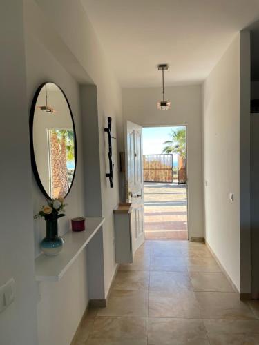 a hallway of a home with a mirror and a door at Casa Helen in Torrox