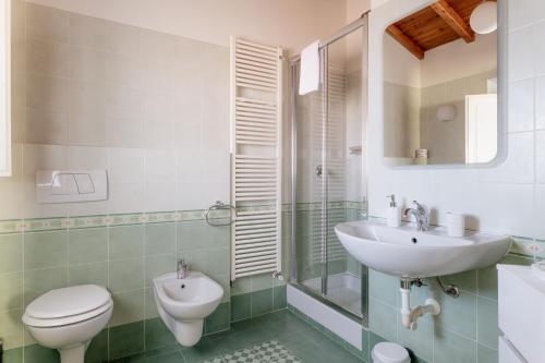 a bathroom with a toilet and a sink at Villa Romantica Wellness & SPA in Lucca