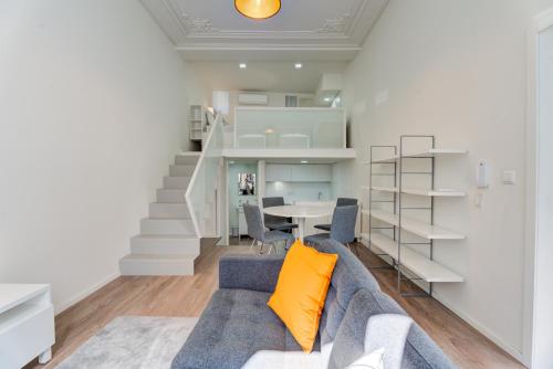 a living room with a couch and a table at Carmo Flats Historic Center - Collection by Perpetual Relax in Braga