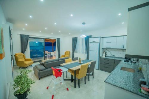 a kitchen and living room with a table and chairs at Villa Blue Coast I & II wBeach and Great Sea View - KALKAN in Kas