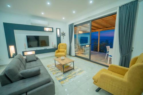 a living room with a couch and chairs and a table at Villa Blue Coast I & II wBeach and Great Sea View - KALKAN in Kas
