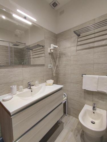 a bathroom with a sink and a toilet at Hotel Delle Ortensie in Fiuggi