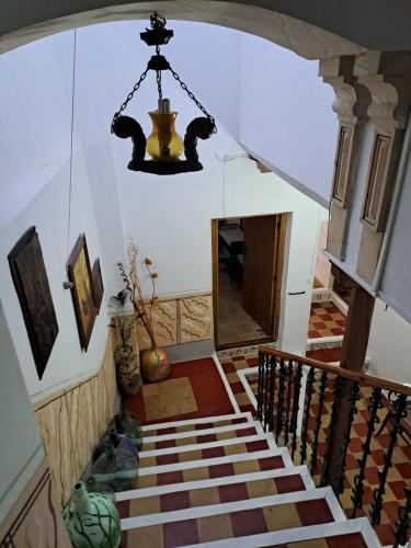 a staircase in a house with a chandelier at Casa de La Parra in Valverde de Júcar