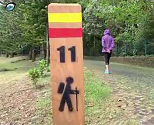 a sign with a teddy bear on it next to a woman at B&C Furnas House in Furnas