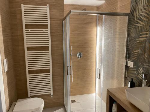 a bathroom with a shower with a toilet and a sink at San Donato Luxury Suite Air-conditioning in Turin