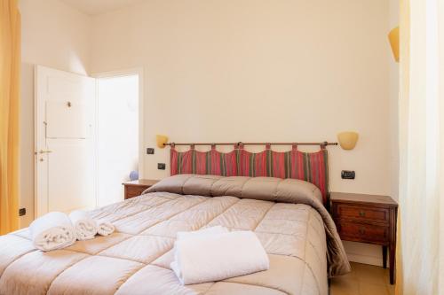 a bedroom with a large bed with towels on it at Villa Romantica Wellness & SPA in Lucca