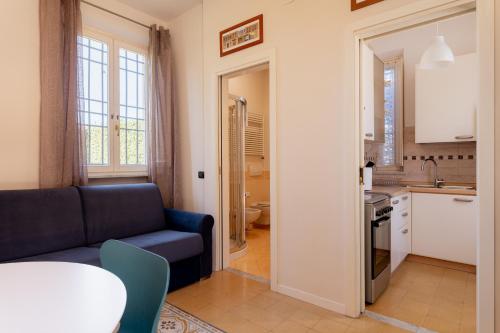 a living room with a couch and a kitchen at Villa Romantica Wellness & SPA in Lucca