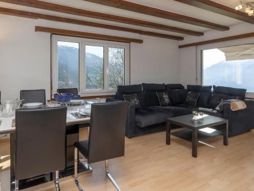 a living room with a couch and a table at Chalet Le Fontany by Interhome in Randogne