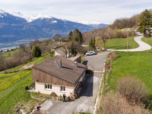 an aerial view of a house with mountains in the background at Chalet Maison Le Fontany by Interhome in Randogne