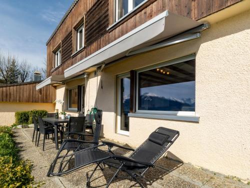 a patio with chairs and a table in front of a building at Chalet Maison Le Fontany by Interhome in Randogne