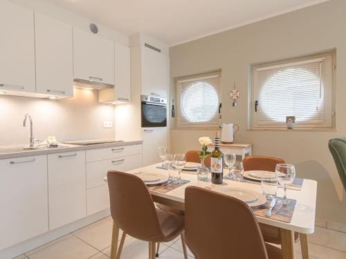 a kitchen and dining room with a table and chairs at Apartment Estepona with parking by Interhome in Mispelburg