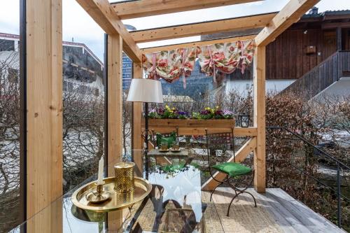 a balcony with a table and a lamp at Haus Alpenveilchen - Appartement 2 in Schönau am Königssee