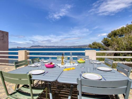 a blue table with chairs and a view of the water at Apartment la Rainette by Interhome in La Madrague