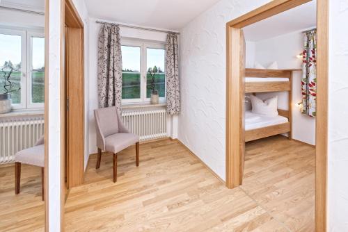 a bedroom with a bunk bed and a mirror at Ferienhotel Starennest in Schindelberg