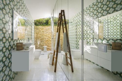 a bathroom with two sinks and two toilets at BelleVue in Cala Vinyes