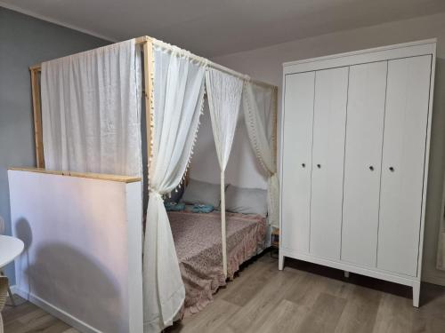 a bedroom with a canopy bed with white curtains at Casa Cirilla in Lerici