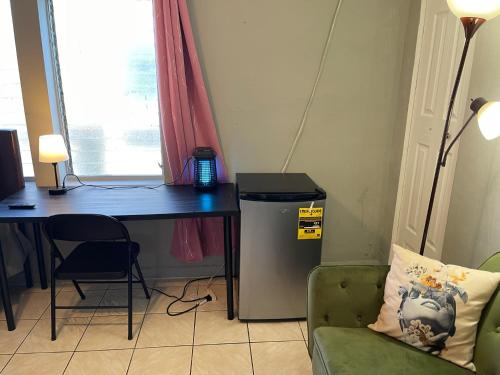 a room with a desk and a table and a chair at Best Value inside City Miami, Near Airport, Beach, Center & Metro in Miami