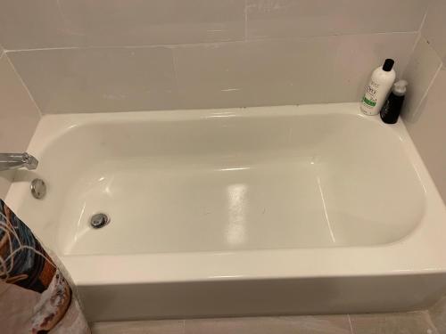a white bath tub sitting in a bathroom at Best Value inside City Miami, Near Airport, Beach, Center & Metro in Miami