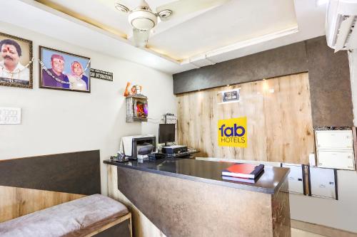 a fast food restaurant with a counter and a desk at FabHotel Welcome in Kānpur