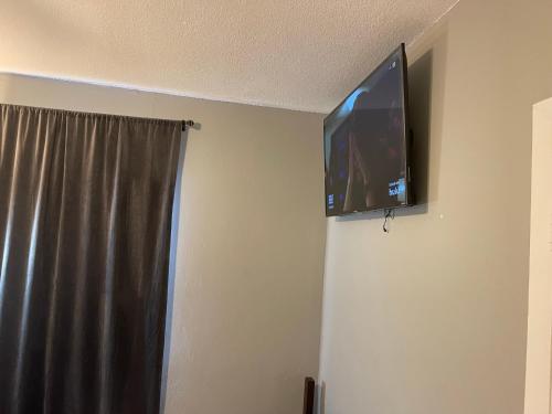 a flat screen tv on a wall in a room at Best Value inside City Miami, Near Airport, Beach, Center & Metro in Miami