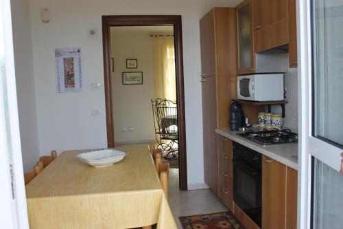 a small kitchen with a wooden table and a dining room at Villa Wight in Olmedo