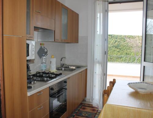 a kitchen with a stove and a sink and a table at Villa Wight in Olmedo