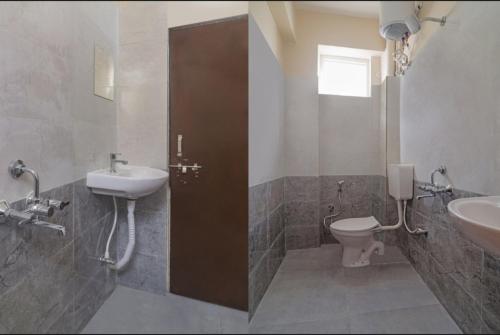 a bathroom with a sink and a toilet at Walk Inn hotel gachibowli in Hyderabad
