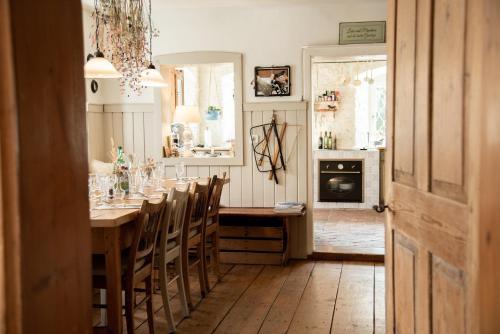 a dining room with a long table and chairs at Großkandlerhaus in Unterdambach