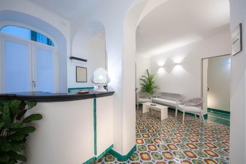 a living room with a table and a chair at Terrazza Duomo in Amalfi