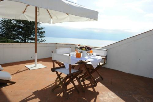 a table and chairs under an umbrella on a patio at Maiori Dream Rental in Maiori