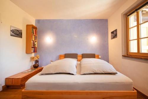 a bedroom with a large bed with two pillows at Das haus in spay an der Mosel mit Sauna in Zell an der Mosel