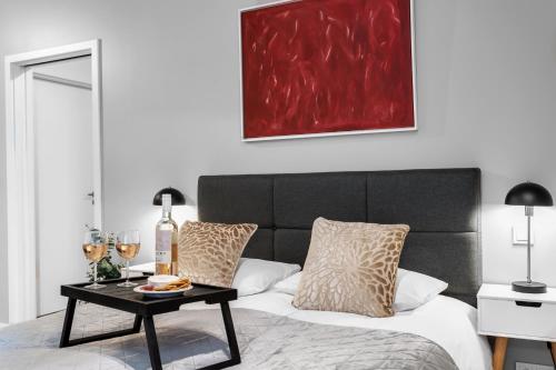 a bedroom with a bed and a table with wine glasses at Tower Apartments in Reykjavík