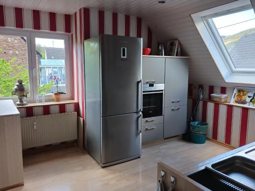 a kitchen with a stainless steel refrigerator and a window at Ferienwohnung Gersch in Wolf