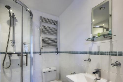 een badkamer met een douche, een wastafel en een spiegel bij The New Rushcart Inn & Country Dining in Sowerby Bridge