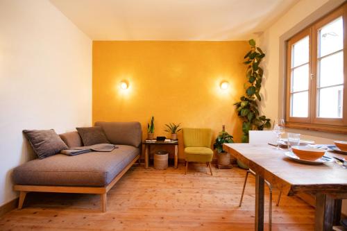 a living room with a couch and a table at Das haus in spay an der Mosel mit Sauna in Zell an der Mosel