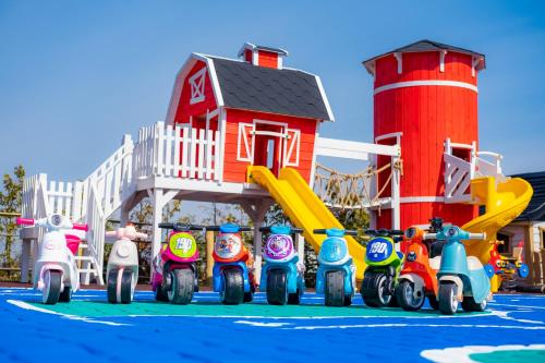 a group of toy motorcycles parked in front of a playground at Panocek i Babka in Białka Tatrzanska