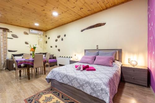a bedroom with a large bed and a dining room at Zois Stone House in Kántanos