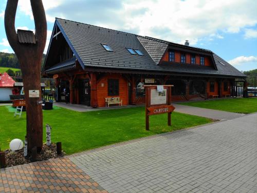 a large building with a sign in front of it at Camp PACHO in Prievidza