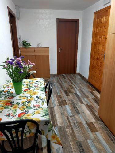 a room with a table with a vase of flowers on it at Affittacamere Montepiano in Roccamontepiano