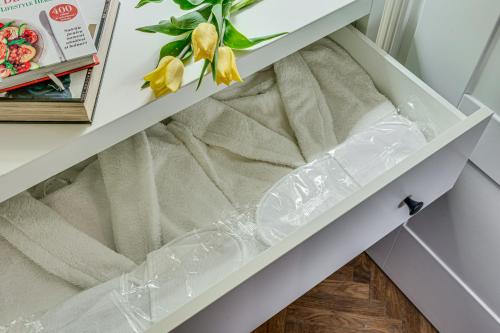a drawer in a cabinet with plastic wrap on it at Central family apartment in Arad